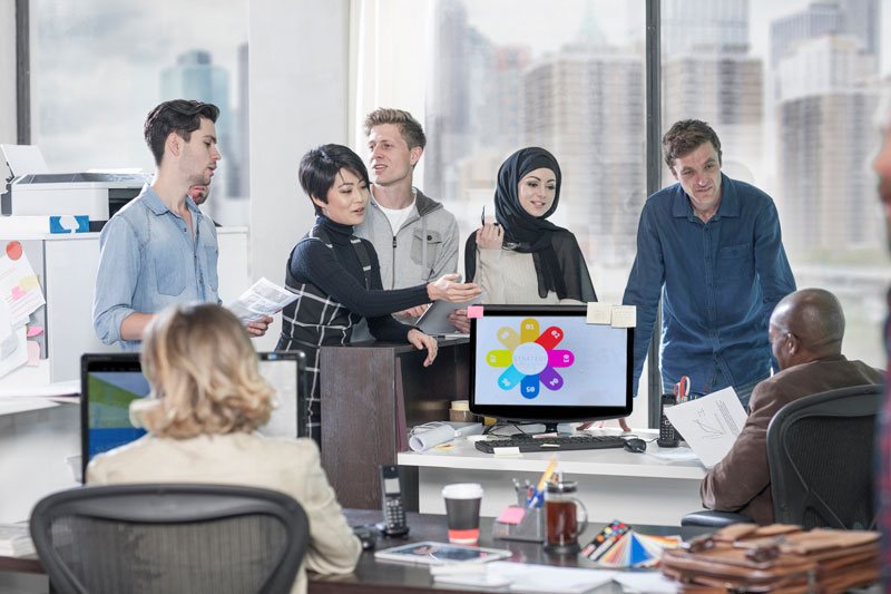 Team collaborating on the cloud-based Bitrix24 workspace in the office